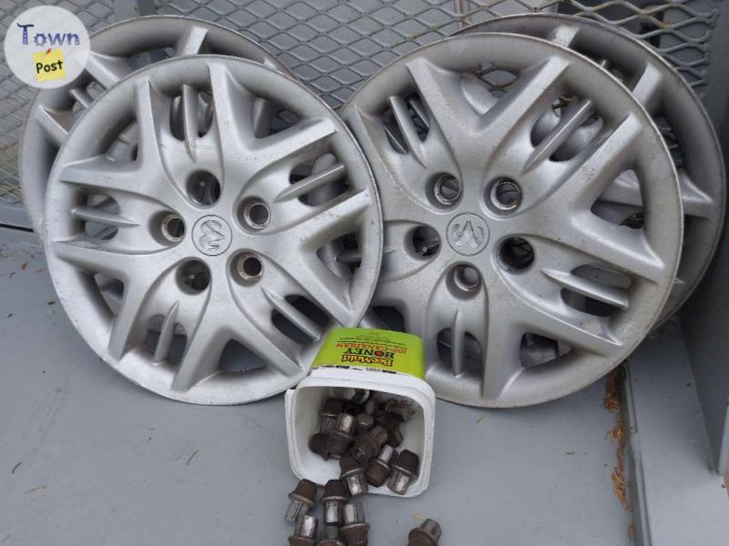 Photo of SET OF 4 HUB CAPS AND LUG NUTS 2007 OR OLDER GRAND CARAVAN